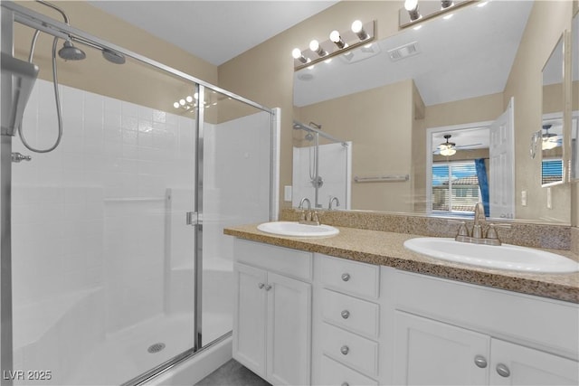 full bath with double vanity, visible vents, a stall shower, and a sink