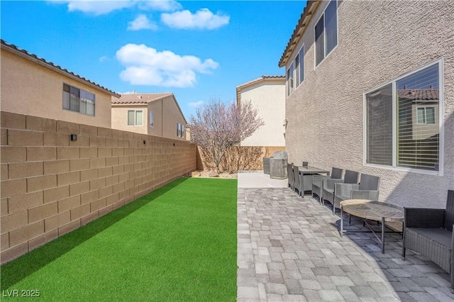 view of yard featuring a patio and a fenced backyard