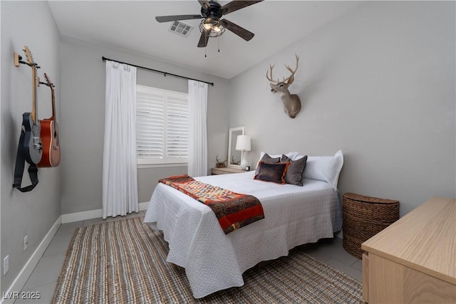 tiled bedroom featuring visible vents, a ceiling fan, and baseboards