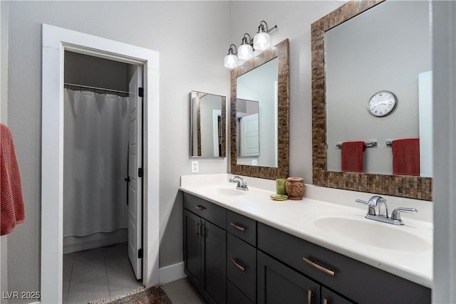 bathroom featuring a sink, double vanity, and tile patterned floors