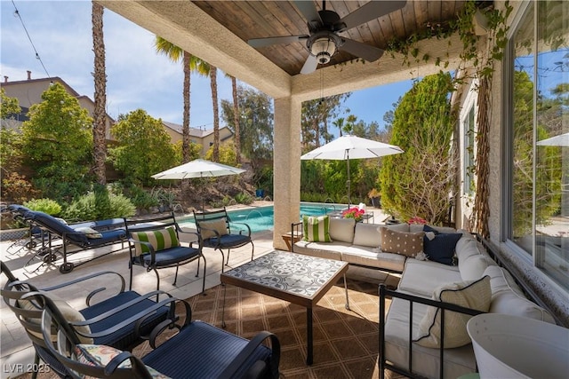 view of patio featuring an outdoor pool, outdoor lounge area, and a ceiling fan