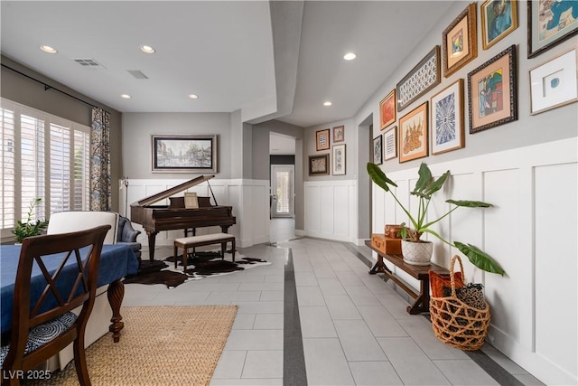 interior space with a wainscoted wall, light tile patterned flooring, recessed lighting, and visible vents