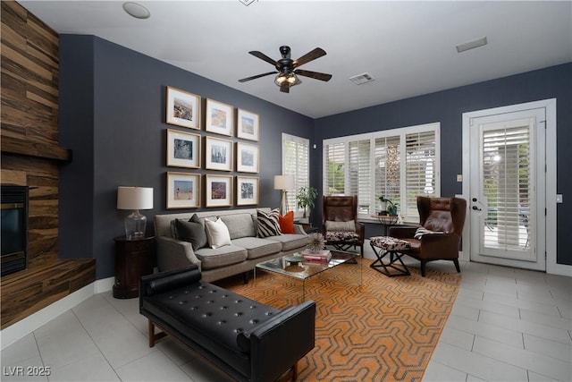 living room with tile patterned floors, plenty of natural light, a fireplace, and visible vents