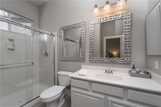 full bath with a shower stall, toilet, and vanity