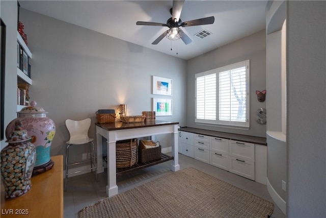 office space with light tile patterned floors, a ceiling fan, and visible vents