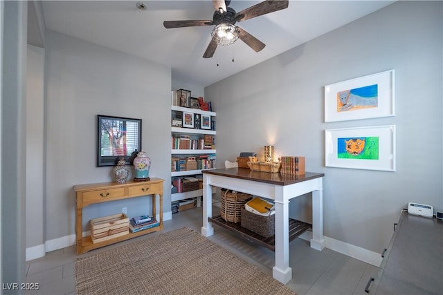 office area featuring a ceiling fan and baseboards