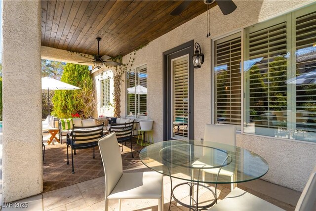 view of patio with outdoor dining area and ceiling fan