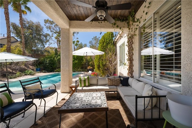 view of patio with an outdoor living space, an outdoor pool, and ceiling fan