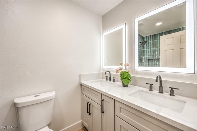 full bath with double vanity, toilet, a shower, and a sink