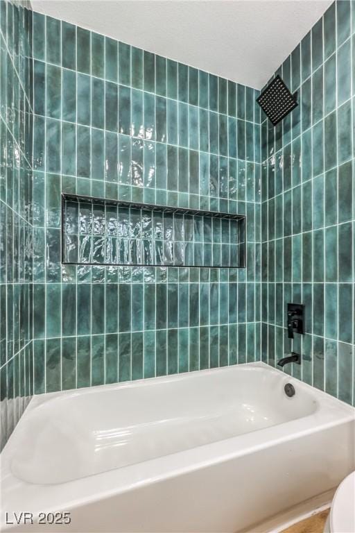 bathroom with tile walls and shower / tub combination