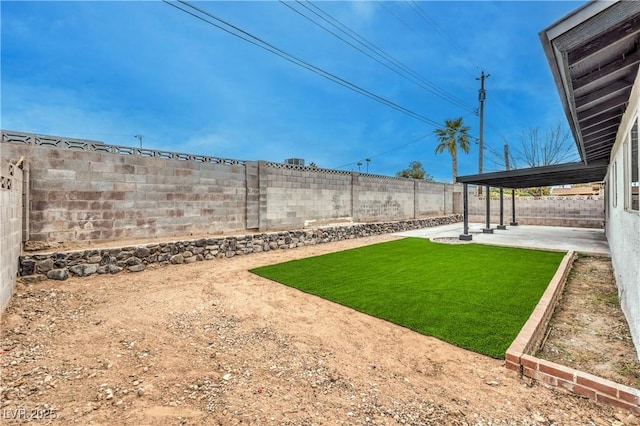 view of yard with a patio and a fenced backyard