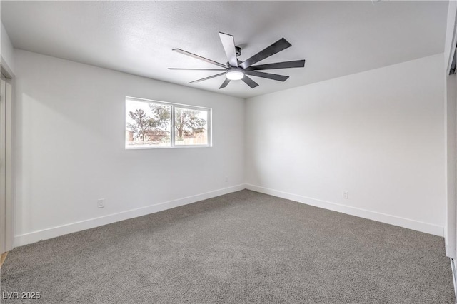 carpeted empty room with a ceiling fan and baseboards