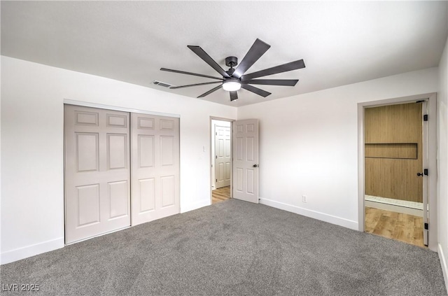 unfurnished bedroom with a closet, visible vents, baseboards, and carpet