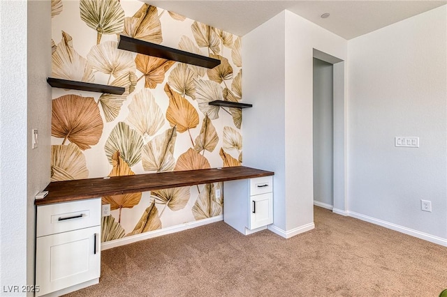 interior space featuring carpet flooring and baseboards