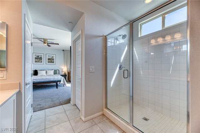 full bath featuring tile patterned floors, a stall shower, ensuite bath, and a ceiling fan