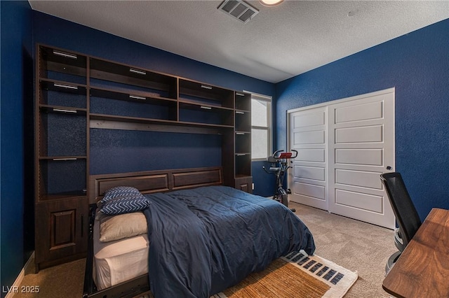 bedroom featuring visible vents, a textured ceiling, a textured wall, and carpet floors