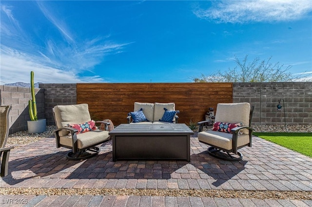 view of patio featuring an outdoor living space and a fenced backyard