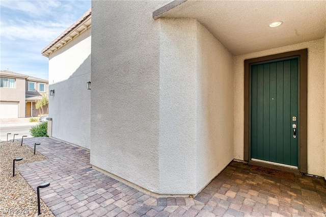 doorway to property with stucco siding and a patio