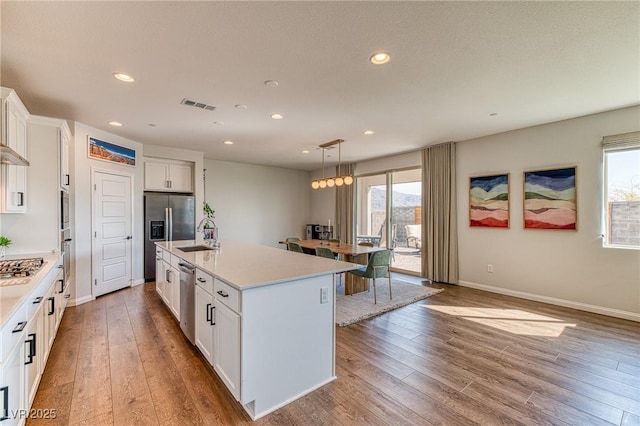 kitchen with visible vents, plenty of natural light, and light countertops