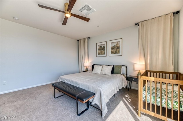 carpeted bedroom with visible vents, baseboards, and ceiling fan