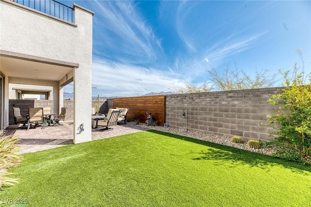 view of yard with a fenced backyard and a patio