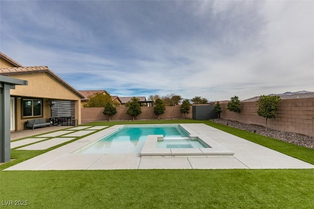 view of swimming pool featuring a lawn, a patio, a pool with connected hot tub, and a fenced backyard