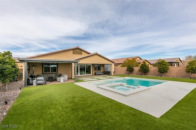 back of house featuring stucco siding, a fenced backyard, a yard, outdoor lounge area, and a patio area