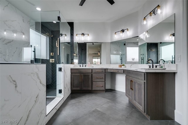 full bathroom with vanity, a ceiling fan, and a marble finish shower