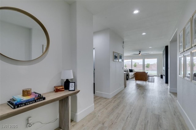 hall with recessed lighting, baseboards, and light wood finished floors