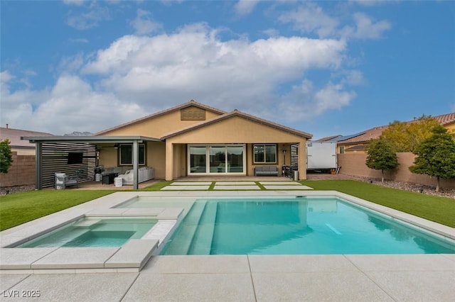 back of house with an outdoor living space, a fenced backyard, an in ground hot tub, and a lawn