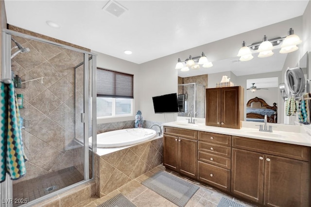 full bathroom featuring double vanity, a sink, tile patterned flooring, a shower stall, and a garden tub