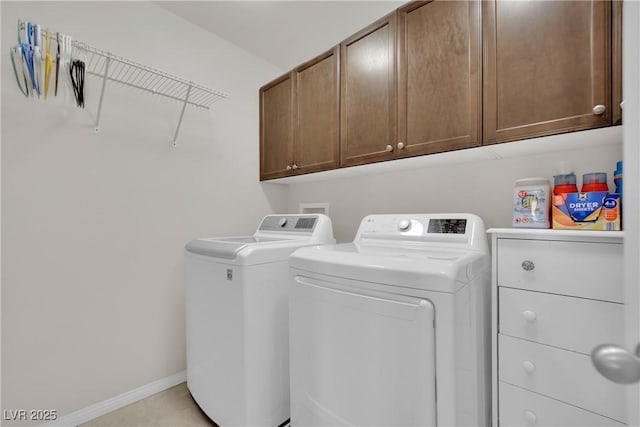 laundry area featuring baseboards, cabinet space, and independent washer and dryer