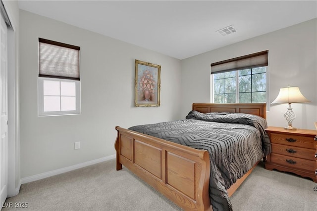 bedroom featuring baseboards, visible vents, and light carpet