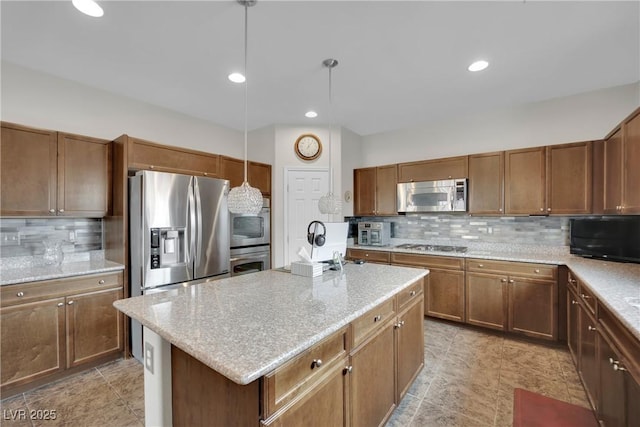 kitchen with a center island, decorative backsplash, stainless steel appliances, and light stone counters