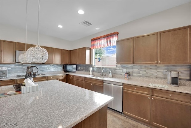 kitchen with visible vents, dishwasher, decorative backsplash, recessed lighting, and a sink