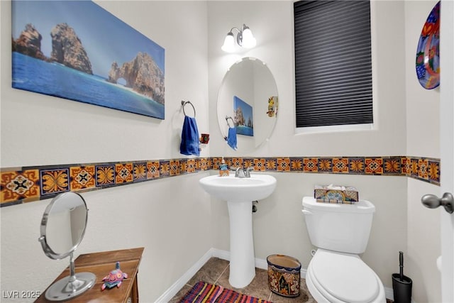 bathroom featuring tile patterned flooring and toilet