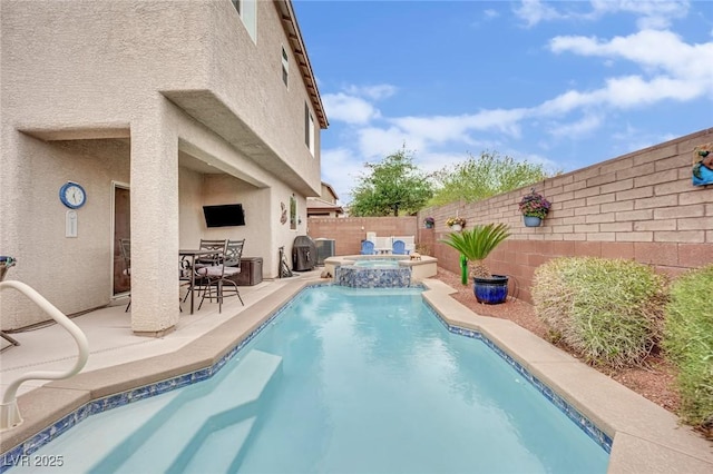 view of swimming pool featuring a patio, a fenced backyard, and a pool with connected hot tub