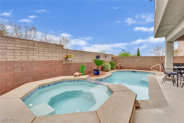 view of swimming pool with a fenced backyard, a patio area, and a pool with connected hot tub