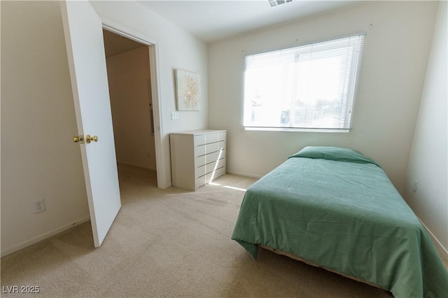 carpeted bedroom featuring visible vents