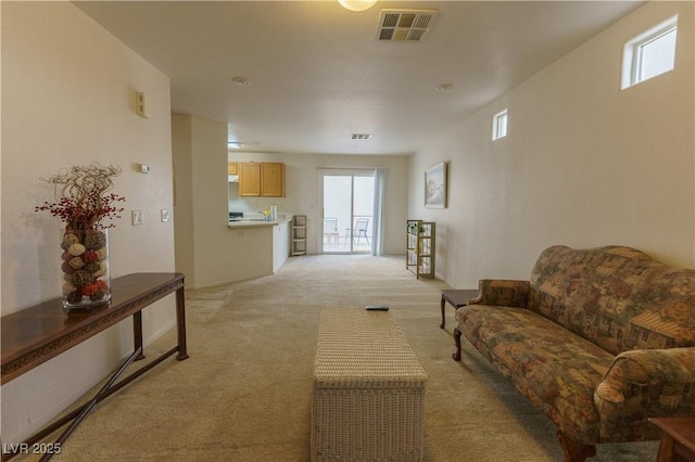 living room featuring visible vents and light colored carpet