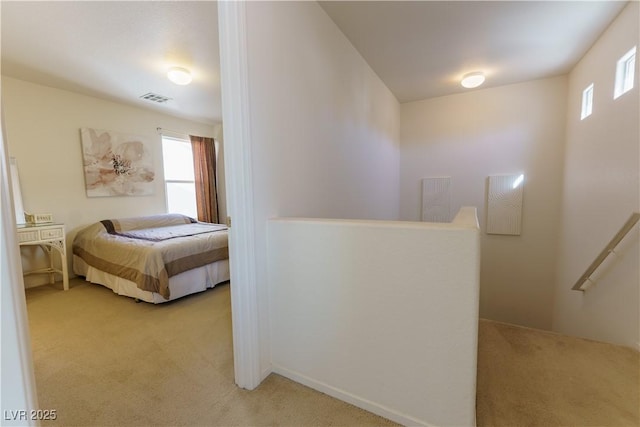 bedroom featuring visible vents and light colored carpet