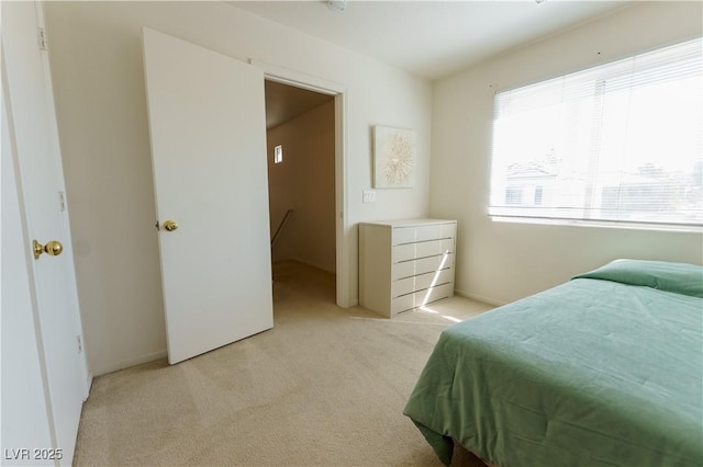 bedroom featuring light carpet