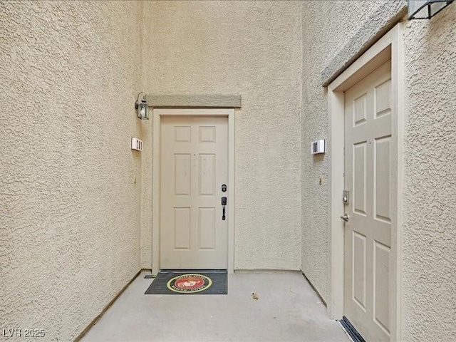 property entrance featuring stucco siding