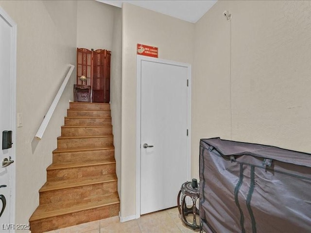 stairway with tile patterned floors