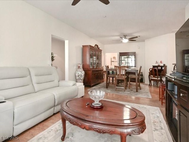 living area with light wood-style flooring and ceiling fan