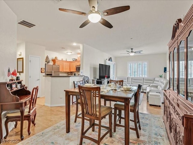 dining room with a ceiling fan and visible vents