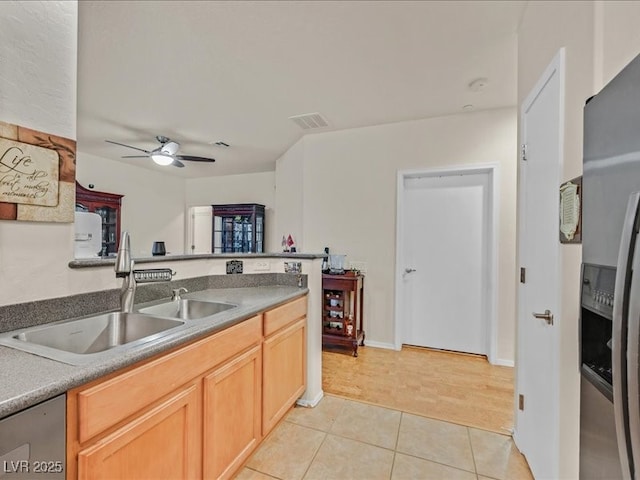 kitchen featuring visible vents, a ceiling fan, a sink, stainless steel appliances, and light tile patterned flooring