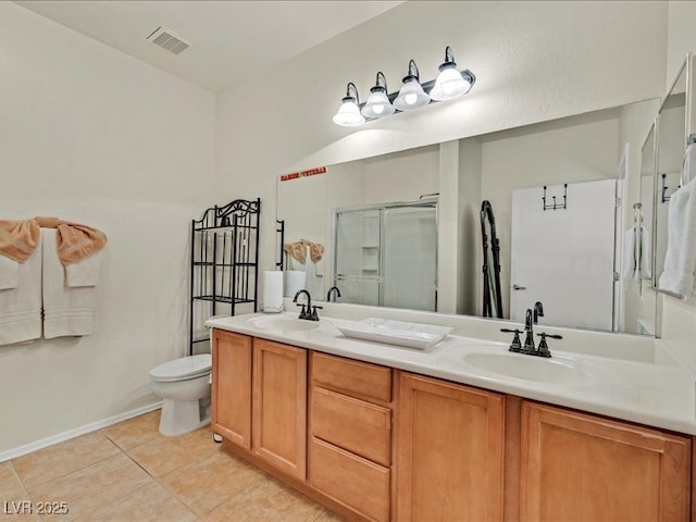 full bath with tile patterned floors, double vanity, a shower stall, and a sink