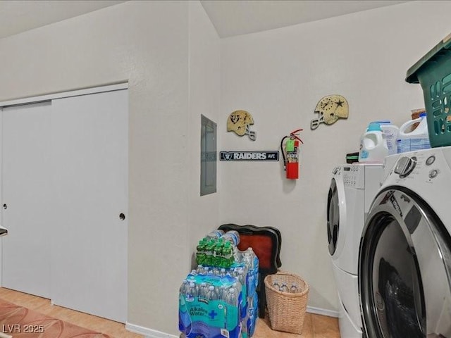 laundry area featuring laundry area, electric panel, and washing machine and clothes dryer