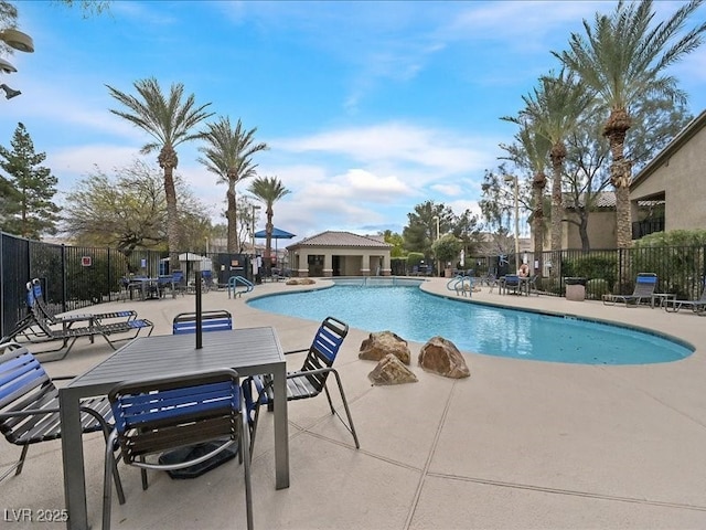 pool featuring a patio area and fence